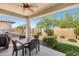 Covered patio with seating area and desert landscaping at 523 N Rainbow Way, Casa Grande, AZ 85194