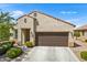 Single-story home with two-car garage and desert landscaping at 523 N Rainbow Way, Casa Grande, AZ 85194