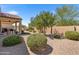 Landscaped backyard with covered patio and gravel at 523 N Rainbow Way, Casa Grande, AZ 85194