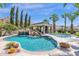Resort-style pool with a waterfall, slide, and covered patio at 3749 E Juniper Cir, Mesa, AZ 85205