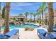 Luxury pool with a waterslide, waterfall feature, and large patio at 3749 E Juniper Cir, Mesa, AZ 85205