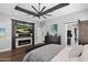 Bright bedroom with fireplace, large TV, and ensuite bathroom access at 3749 E Juniper Cir, Mesa, AZ 85205