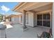 Covered patio with a column, wrought iron door, and view of neighborhood at 14709 W Greystone Dr, Sun City West, AZ 85375