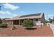 House exterior with solar panels and covered patio at 14709 W Greystone Dr, Sun City West, AZ 85375