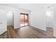 Bright bedroom with wood-look flooring and access to balcony at 4303 E Cactus Rd # 441, Phoenix, AZ 85032
