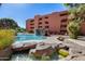Inviting pool area with waterfall and surrounding landscaping at 4303 E Cactus Rd # 441, Phoenix, AZ 85032