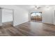 Open living room with wood-look floors and access to private balcony at 4303 E Cactus Rd # 441, Phoenix, AZ 85032