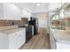Modern kitchen with white cabinets and mosaic backsplash at 4303 E Cactus Rd # 441, Phoenix, AZ 85032