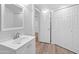 Clean bathroom with white vanity, mirror and wood-look flooring at 4303 E Cactus Rd # 441, Phoenix, AZ 85032