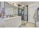 Modern bathroom with double sinks, a walk-in shower, and stylish tile at 35925 N 30Th Dr, Phoenix, AZ 85086