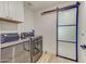 Convenient laundry room with washer, dryer, and barn door at 35925 N 30Th Dr, Phoenix, AZ 85086