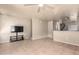 Open living room with tile floors, kitchen view, and mounted TV at 2150 W Alameda Rd # 1273, Phoenix, AZ 85085