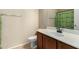 Bathroom with wood cabinets and Seahawks shower curtain at 2150 W Alameda Rd # 1273, Phoenix, AZ 85085