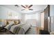 Spacious bedroom with a ceiling fan and a rustic barn door at 1642 W Capri Ave, Mesa, AZ 85202
