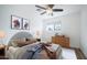Neutral-toned bedroom with a wooden dresser and ceiling fan at 1642 W Capri Ave, Mesa, AZ 85202