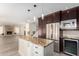 Open concept kitchen with island and view into living room at 5725 E Evans Dr, Scottsdale, AZ 85254