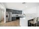 Modern kitchen with dark gray cabinets, quartz countertops, and stainless steel appliances at 1642 W Capri Ave, Mesa, AZ 85202