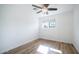 Bright bedroom featuring light wood flooring and ceiling fan at 1642 W Capri Ave, Mesa, AZ 85202