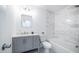Modern bathroom with white marble tile and gray vanity at 1642 W Capri Ave, Mesa, AZ 85202