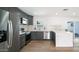 Modern kitchen with dark gray cabinets, quartz countertops, and stainless steel appliances at 1642 W Capri Ave, Mesa, AZ 85202