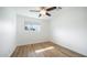 Bright bedroom featuring light wood flooring and ceiling fan at 1642 W Capri Ave, Mesa, AZ 85202