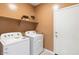 Laundry room with washer, dryer, and additional shelving at 1563 E Lardner Dr, Casa Grande, AZ 85122