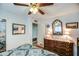 Bright bedroom with a dresser and ceiling fan at 5862 E Duncan St, Mesa, AZ 85205