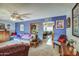 Living room with purple walls and a view to dining area at 5862 E Duncan St, Mesa, AZ 85205