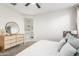 Bedroom with dresser, large mirror, and view into the ensuite bathroom at 20442 E Rosa Rd, Queen Creek, AZ 85142