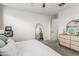 Bright bedroom featuring a queen-size bed, full-length mirror, and dresser at 20442 E Rosa Rd, Queen Creek, AZ 85142
