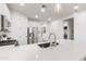 Modern kitchen with white cabinets and a stainless steel sink at 20442 E Rosa Rd, Queen Creek, AZ 85142