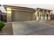 House exterior featuring a two-car garage and front yard landscaping at 20442 E Rosa Rd, Queen Creek, AZ 85142