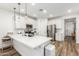 Modern kitchen with white cabinets, stainless steel appliances, and an island at 20442 E Rosa Rd, Queen Creek, AZ 85142