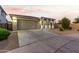 Front view of a single-story home with a two-car garage and desert landscaping at 20442 E Rosa Rd, Queen Creek, AZ 85142