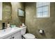 Small bathroom with a single sink vanity and textured green walls at 20442 E Rosa Rd, Queen Creek, AZ 85142