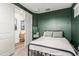 Guest bedroom with a full-size bed and dark green painted walls at 20442 E Rosa Rd, Queen Creek, AZ 85142