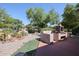 Landscaped backyard with a stone fireplace and gravel at 2448 E Fiesta Dr, Casa Grande, AZ 85194