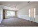 Bright living room featuring carpet, large windows, and a ceiling fan at 2448 E Fiesta Dr, Casa Grande, AZ 85194