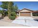 Single-story home with a two-car garage and landscaped front yard at 2448 E Fiesta Dr, Casa Grande, AZ 85194