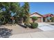 Single-story home with a two-car garage and mature landscaping at 2448 E Fiesta Dr, Casa Grande, AZ 85194