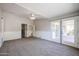 Spacious bedroom with carpet, double doors leading to a patio, and a ceiling fan at 2448 E Fiesta Dr, Casa Grande, AZ 85194