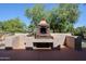 Outdoor BBQ area with stone fireplace and built-in seating at 2448 E Fiesta Dr, Casa Grande, AZ 85194