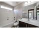 Bathroom with single vanity, tub, and large mirror at 2448 E Fiesta Dr, Casa Grande, AZ 85194