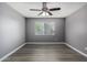 Bright bedroom with ceiling fan and laminate wood floors at 2146 W Isabella Ave # 127, Mesa, AZ 85202