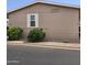 Side view of tan mobile home with shrubbery at 11596 W Sierra Dawn Blvd # 36, Surprise, AZ 85378