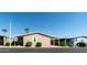 Tan mobile home with covered walkway and landscaping at 11596 W Sierra Dawn Blvd # 36, Surprise, AZ 85378