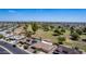 Aerial view of home on golf course with pool and solar panels at 9821 N 103Rd Ave, Sun City, AZ 85351