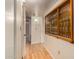 Hallway with bathroom access and built-in display cabinet at 9821 N 103Rd Ave, Sun City, AZ 85351