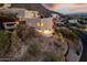 Luxury home nestled on a hillside with city views at dusk at 7201 N 23Rd Pl, Phoenix, AZ 85020