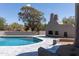 Inviting pool area with a built-in fireplace and seating at 30600 N Pima Rd # 58, Scottsdale, AZ 85266